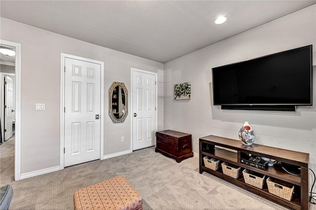 living area with light colored carpet, recessed lighting, and baseboards