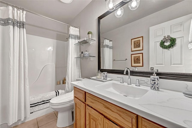 bathroom with vanity, toilet, and tile patterned flooring