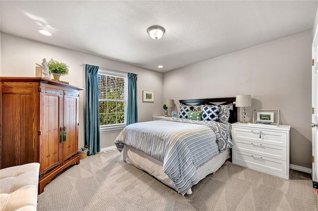 bedroom with baseboards, recessed lighting, and light carpet