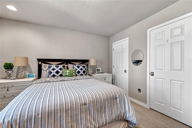 bedroom featuring baseboards, recessed lighting, and light colored carpet