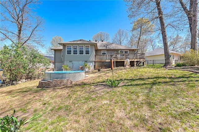 back of property featuring a lawn, a deck, and fence
