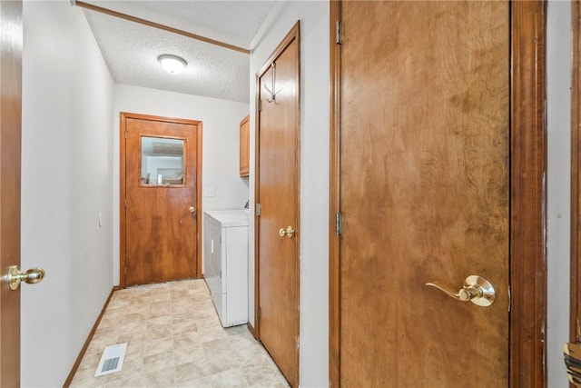 1622 2nd St, Westville, OK 74965 - laundry area featuring a textured ceiling, visible vents, cabinet space, and baseboards