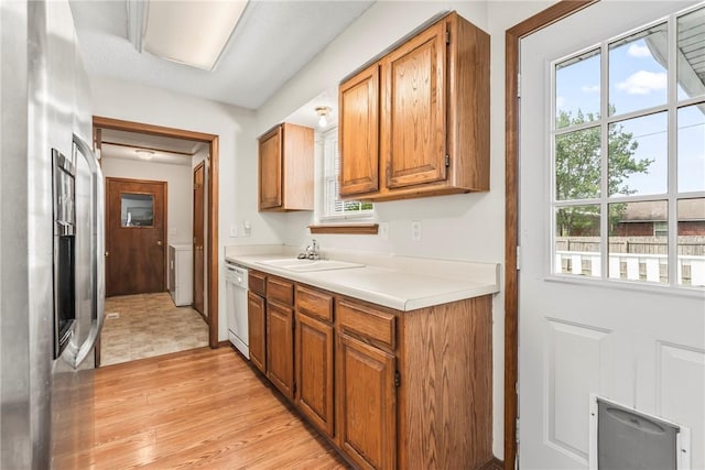 1622 2nd St, Westville, OK 74965 - kitchen featuring light wood-style flooring, brown cabinetry, light countertops, a sink, and stainless steel refrigerator with ice dispenser