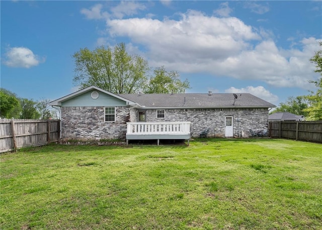 1622 2nd St, Westville, OK 74965 - rear view of house featuring brick siding, a fenced backyard, a wooden deck, and a lawn