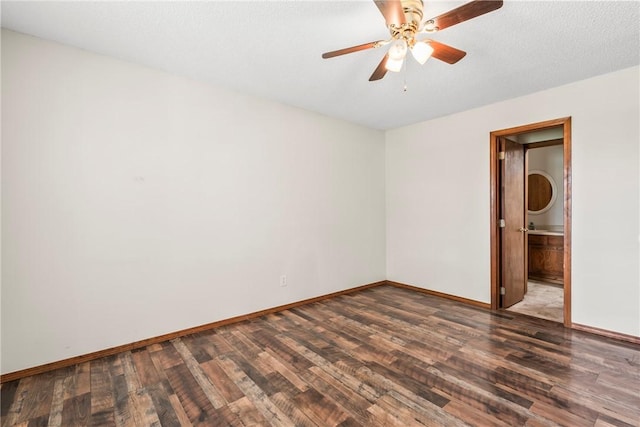1622 2nd St, Westville, OK 74965 - unfurnished bedroom featuring baseboards, wood finished floors, ceiling fan, and connected bathroom