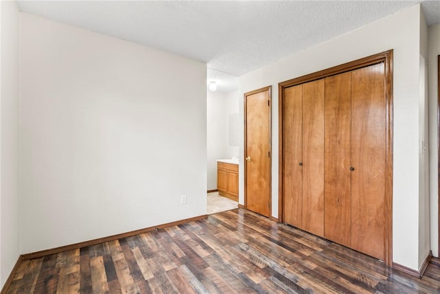 1622 2nd St, Westville, OK 74965 - unfurnished bedroom featuring baseboards, dark wood-style flooring, and a closet
