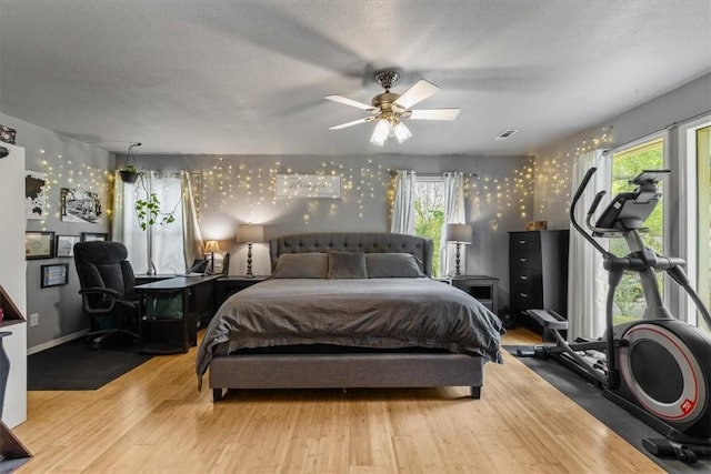 bedroom with multiple windows, wood finished floors, and visible vents