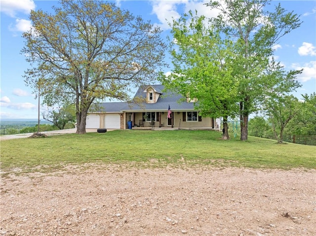 view of front of home featuring a front lawn, driveway, a garage, and covered porch
