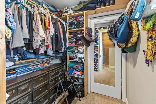 walk in closet with carpet flooring
