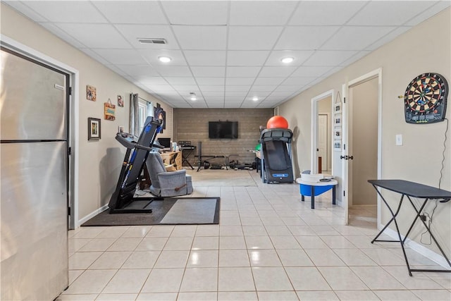exercise area featuring recessed lighting, a paneled ceiling, light tile patterned flooring, visible vents, and baseboards