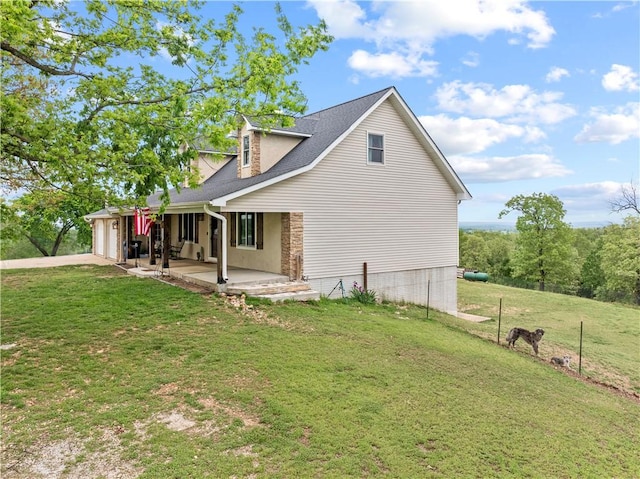 view of property exterior featuring a porch, a yard, a shingled roof, and an attached garage