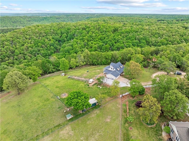 birds eye view of property featuring a view of trees