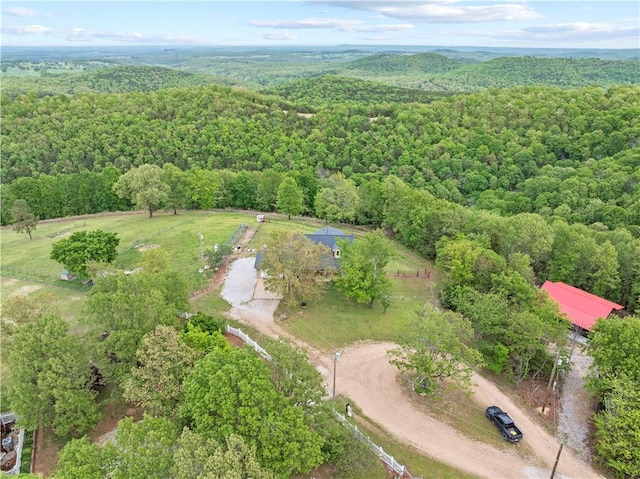 drone / aerial view featuring a forest view