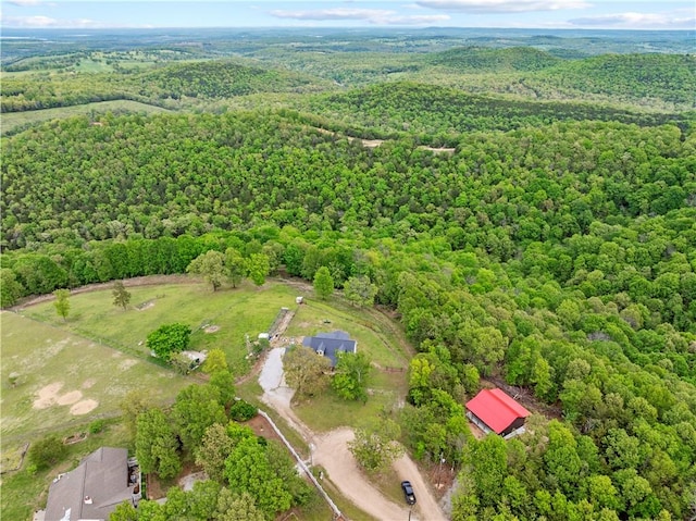 birds eye view of property featuring a view of trees