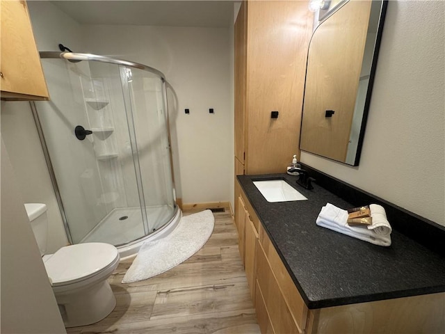 794 NC-3986, Jasper, AR 72641 - full bath featuring wood finished floors, a shower stall, toilet, and vanity