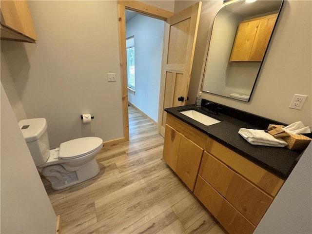 794 NC-3986, Jasper, AR 72641 - half bath featuring toilet, vanity, wood finished floors, and baseboards