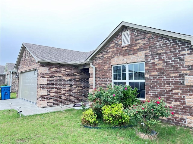 single story home with driveway, a garage, a shingled roof, and brick siding