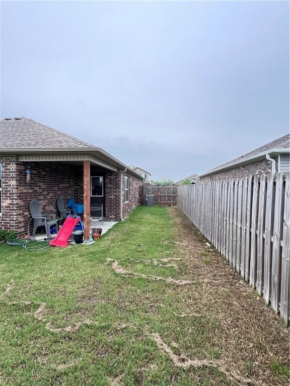 view of yard with a patio area and a fenced backyard