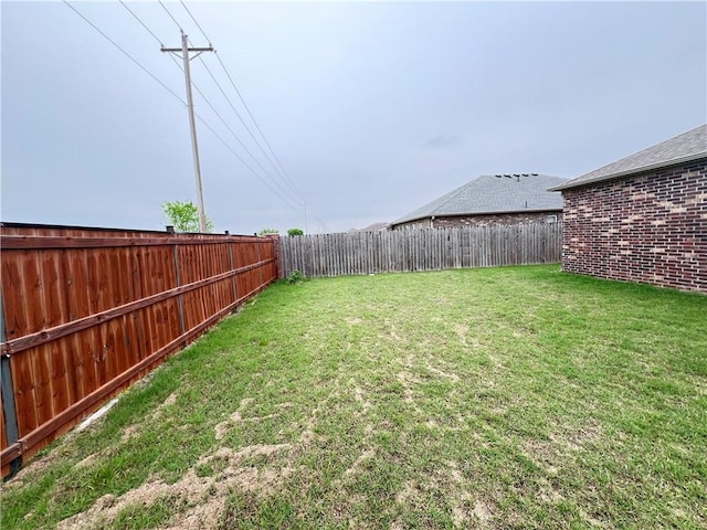 view of yard with a fenced backyard