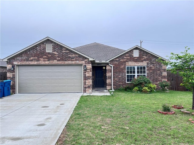 ranch-style house featuring brick siding, fence, a garage, driveway, and a front yard