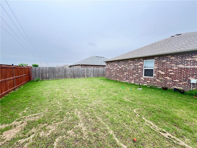 view of yard with a fenced backyard