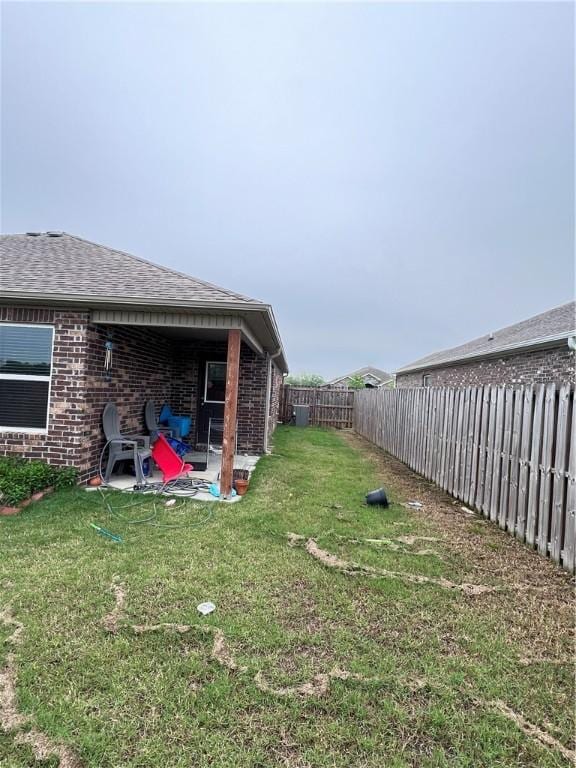 view of yard featuring a patio and a fenced backyard