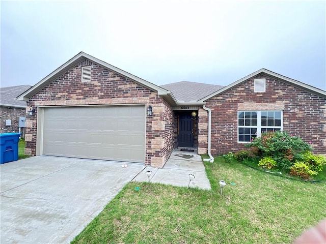 single story home featuring concrete driveway, a front yard, an attached garage, and brick siding