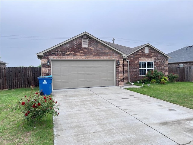 ranch-style home with brick siding, fence, a garage, driveway, and a front lawn