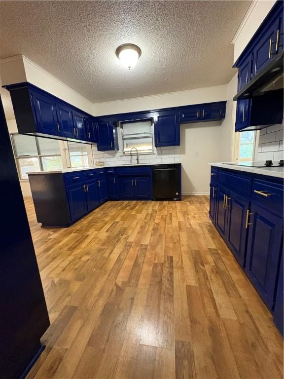 8455 Par Ln, Rogers, AR 72756 - kitchen with blue cabinets, black appliances, a textured ceiling, light countertops, and tasteful backsplash