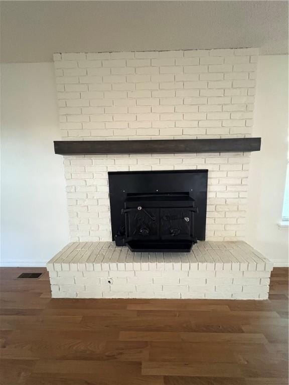 8455 Par Ln, Rogers, AR 72756 - detailed view of a brick fireplace, baseboards, and wood finished floors