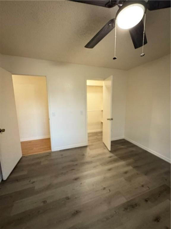 unfurnished bedroom with wood finished floors, ceiling fan, and baseboards
