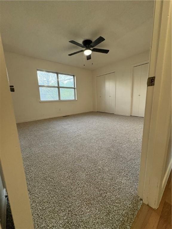 unfurnished room featuring ceiling fan and baseboards