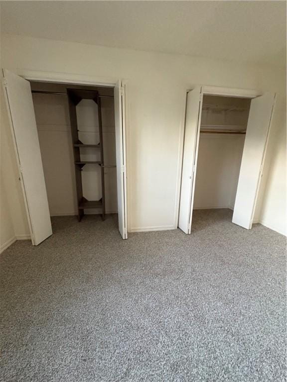 8455 Par Ln, Rogers, AR 72756 - unfurnished bedroom featuring light colored carpet and multiple closets