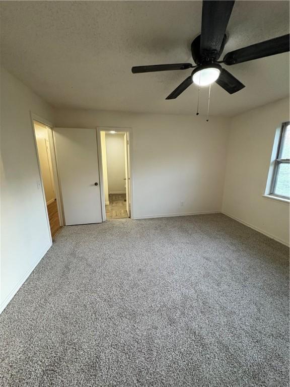 8455 Par Ln, Rogers, AR 72756 - unfurnished room with baseboards, ceiling fan, and light colored carpet