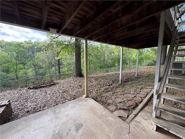 view of patio featuring cooling unit and a forest view