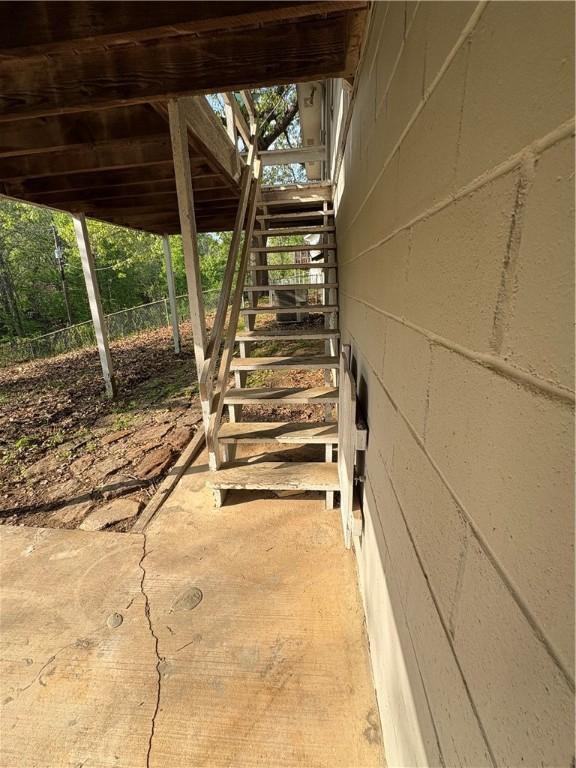 exterior space featuring fence and stairs