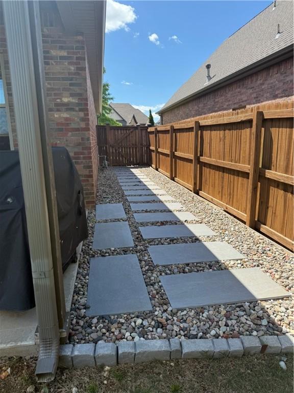 fenced backyard with a patio area
