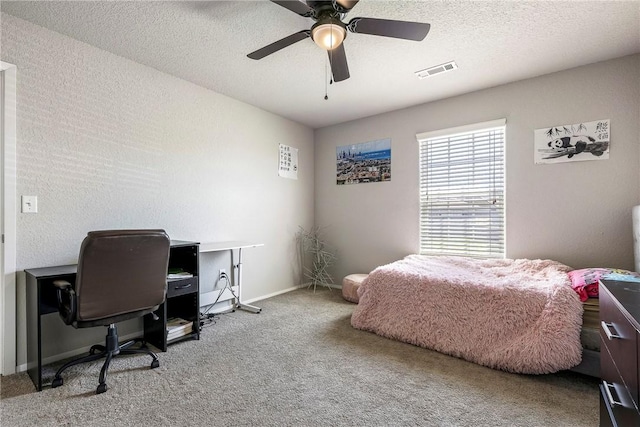 bedroom with carpet floors, baseboards, visible vents, a ceiling fan, and a textured ceiling