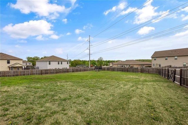 view of yard featuring a residential view and a fenced backyard