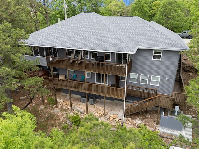 15 Serenity Ln, Holiday Island, AR 72631 - rear view of house featuring a shingled roof and a deck