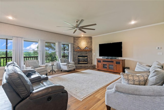 15 Serenity Ln, Holiday Island, AR 72631 - living room featuring ceiling fan, a stone fireplace, light wood-style floors, ornamental molding, and recessed lighting