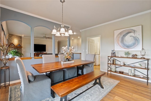 15 Serenity Ln, Holiday Island, AR 72631 - dining space featuring ceiling fan, wood finished floors, ornamental molding, arched walkways, and a chandelier