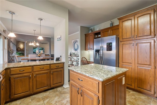 15 Serenity Ln, Holiday Island, AR 72631 - kitchen featuring stainless steel fridge, brown cabinets, light stone counters, a chandelier, and crown molding
