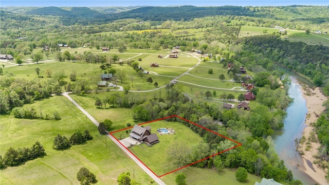 aerial view with a rural view, a water view, and a wooded view