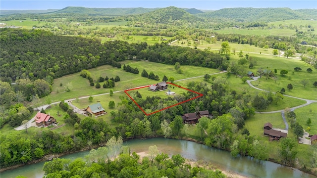 aerial view with a water and mountain view and a rural view