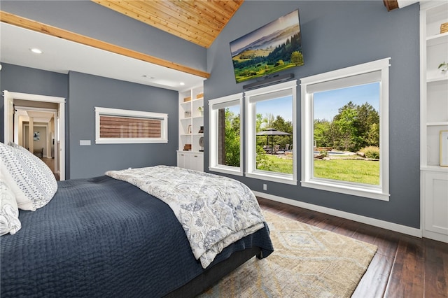 bedroom with dark wood-style floors, multiple windows, vaulted ceiling, and baseboards
