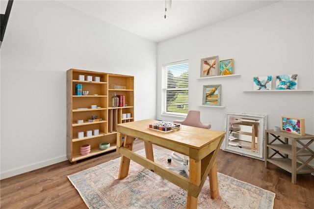 office area with baseboards and wood finished floors