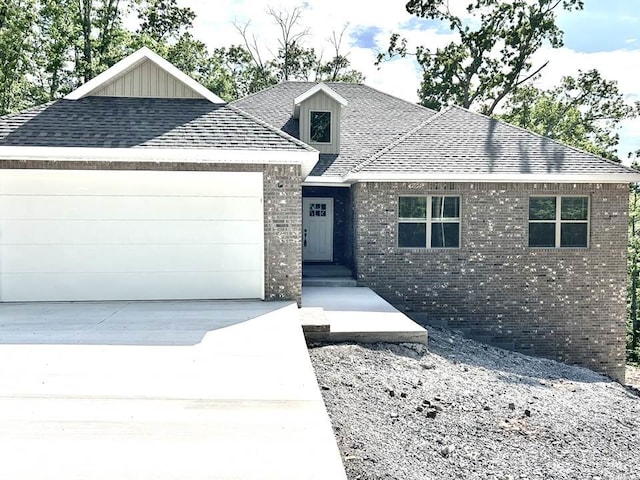 1 Insh Cir, Bella Vista, AR 72715 - view of front of home featuring brick siding, roof with shingles, a garage, and driveway