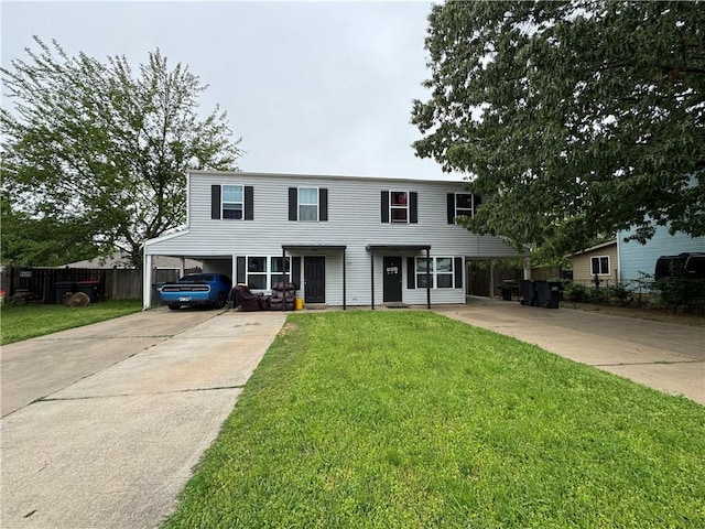 view of front of home featuring a front lawn, driveway, a carport, and fence