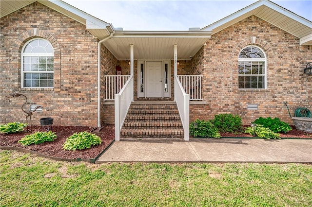 entrance to property featuring brick siding